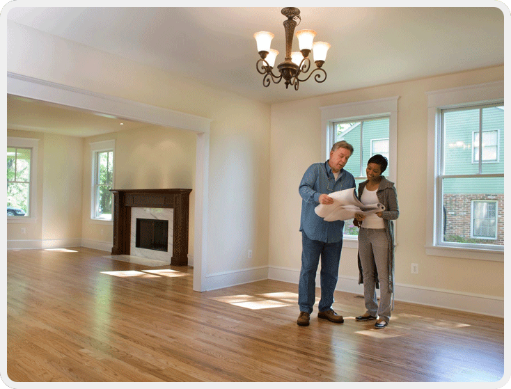 A man and woman standing in the living room.