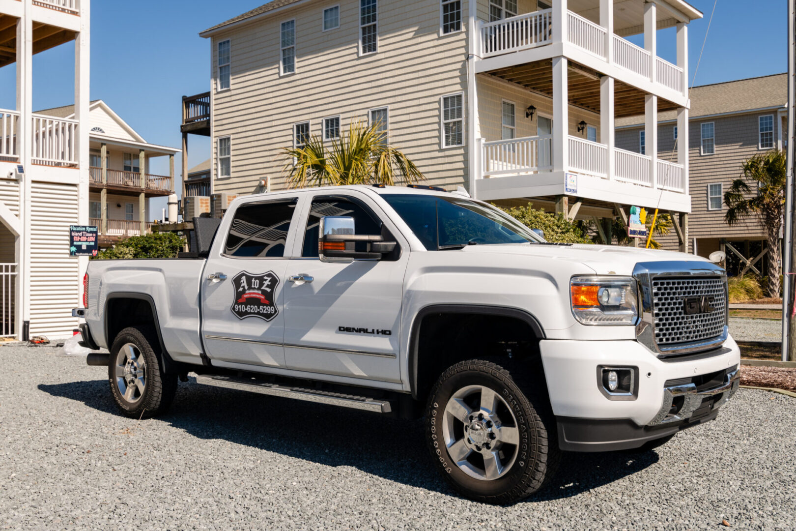 A white truck parked in front of a house.