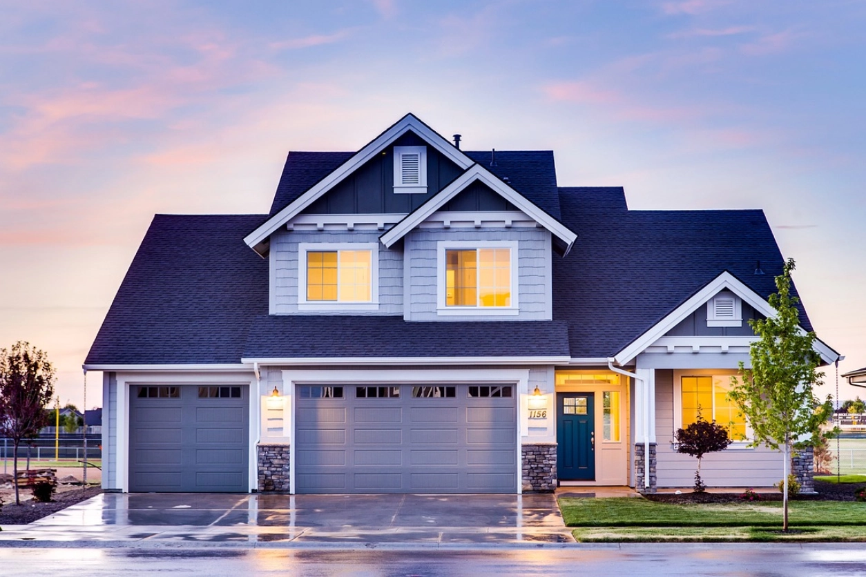 A house with two garage doors and a driveway.