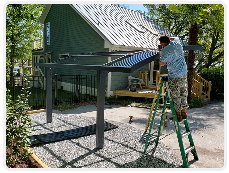 A man on a ladder painting the roof of a house.