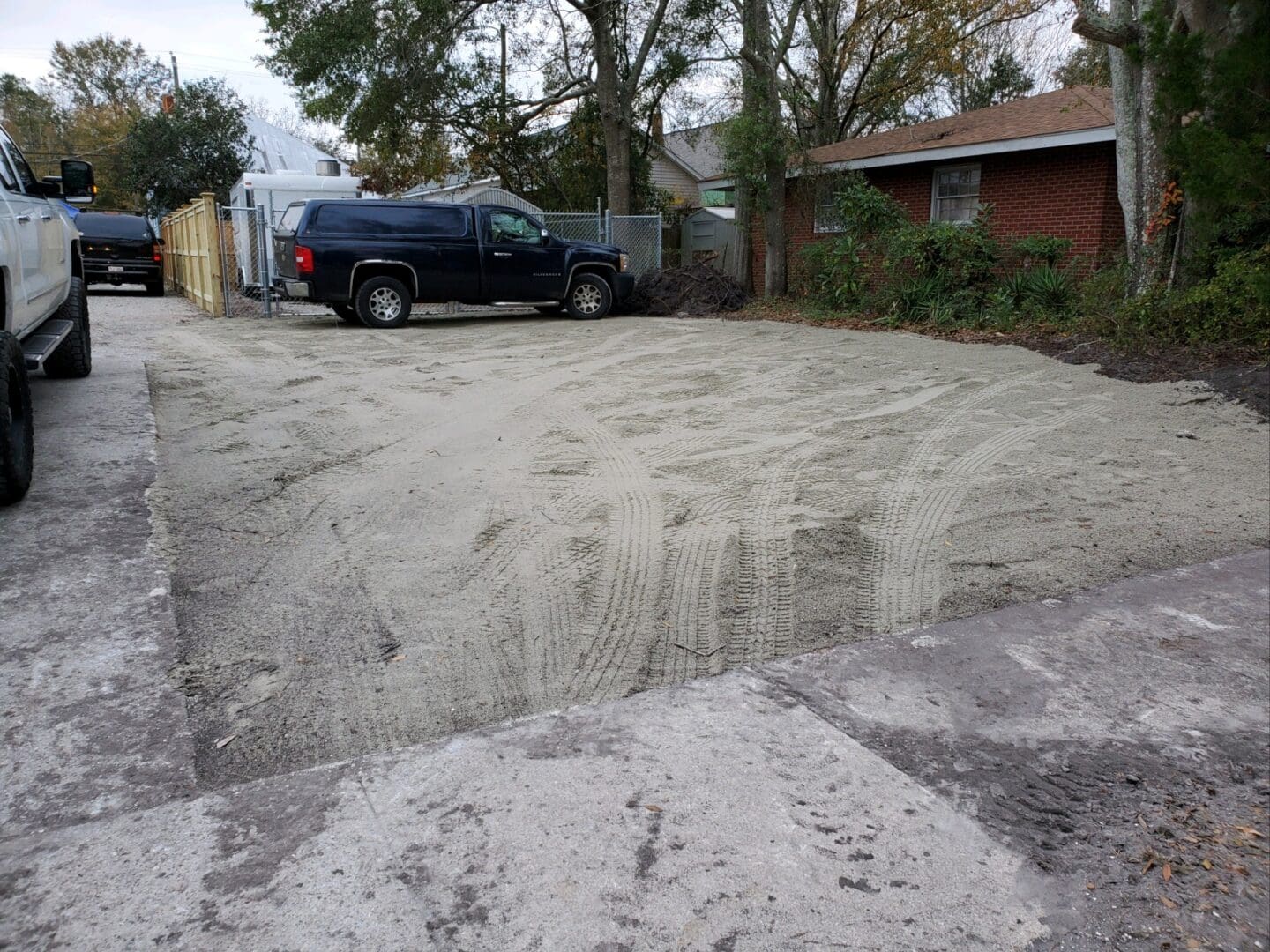 A truck parked in the middle of a driveway.